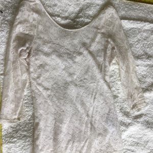 Form fitting, hip length lace shirt.